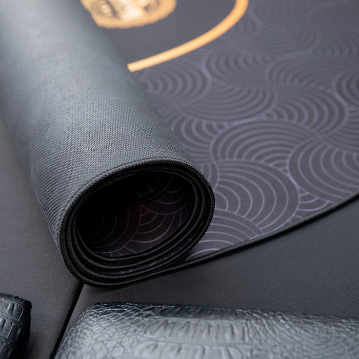 Rolling out a textured gray yoga mat with a subtle pattern.
