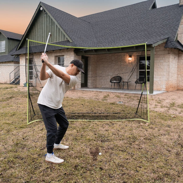 Person practicing golf swings in a home-built golf netting system.