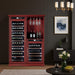 Red wine cabinet in a room with a dark wall, framed picture, and small table with a glass of wine and fruit bowl.