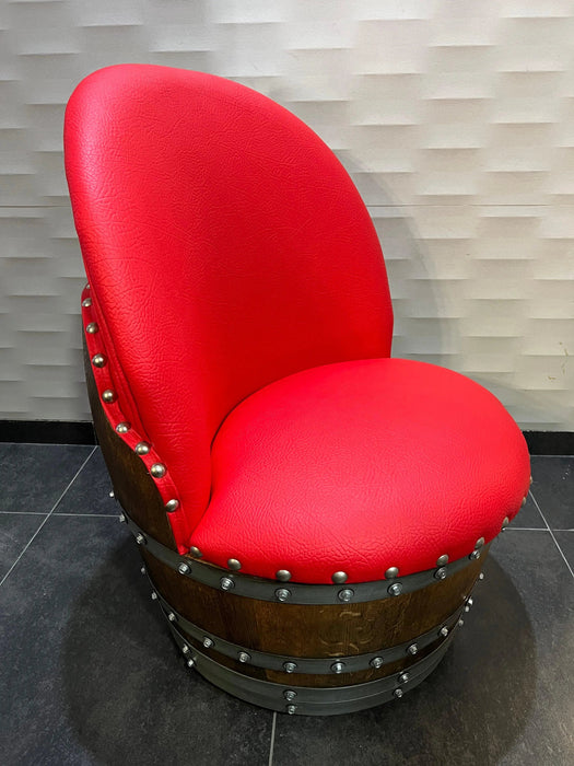 Red chair with wooden base on a tiled floor against a textured wall.