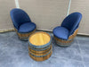 Two barrel-shaped chairs with blue cushioned seats on a tiled floor.