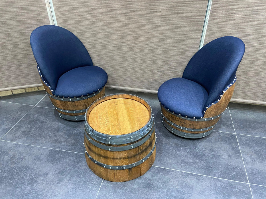 Two barrel-shaped chairs with blue cushioned seats on a tiled floor.
