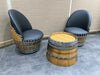 Two barrel-shaped chairs with black seats on a tiled floor.
