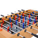 Close-up of a foosball table with red and blue player figures on a white background