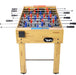 Foosball table with wooden finish and red, blue, and white figures on a white background