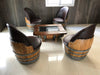 Wooden barrel chairs with a matching table on a tiled floor.