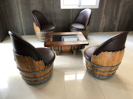 Wooden barrel chairs with a matching table on a tiled floor.