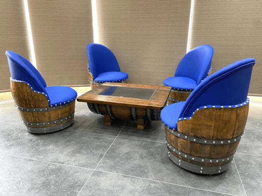 Wooden barrel chairs with blue seats around a wooden table on a tiled floor.