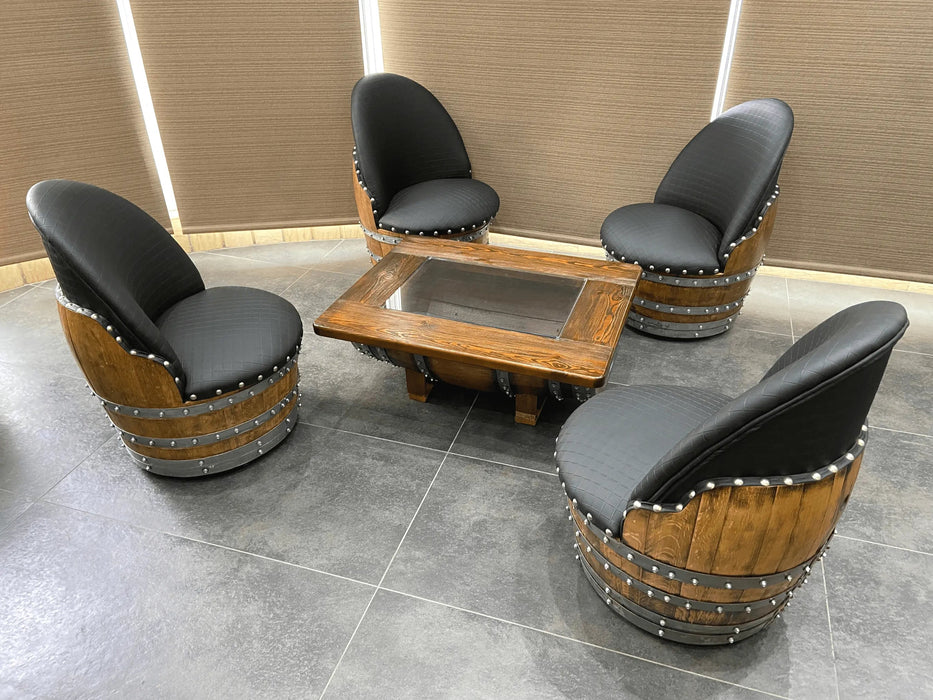 Wooden barrel chairs with black seats arranged around a wooden table on a tiled floor.