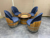 Wooden barrel chairs with blue cushioned seats on a tiled floor.