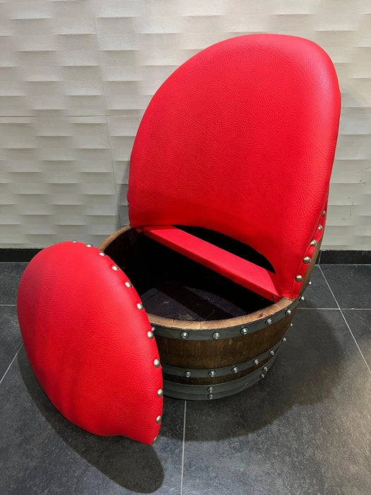 Red upholstered chair with wooden base on a tiled floor.