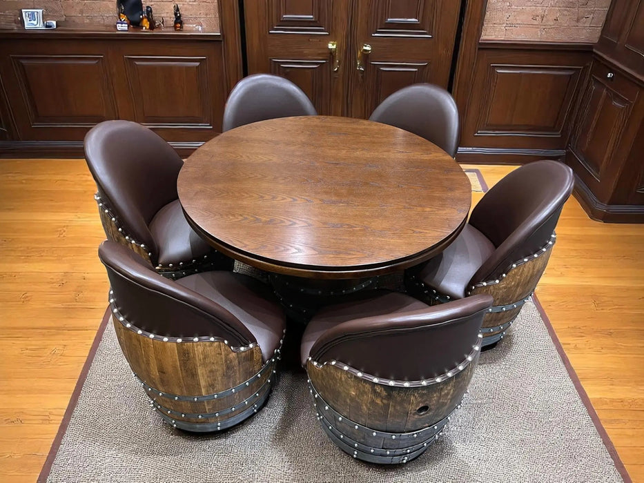 Round wooden table with six matching chairs in a room with wooden flooring and cabinets.
