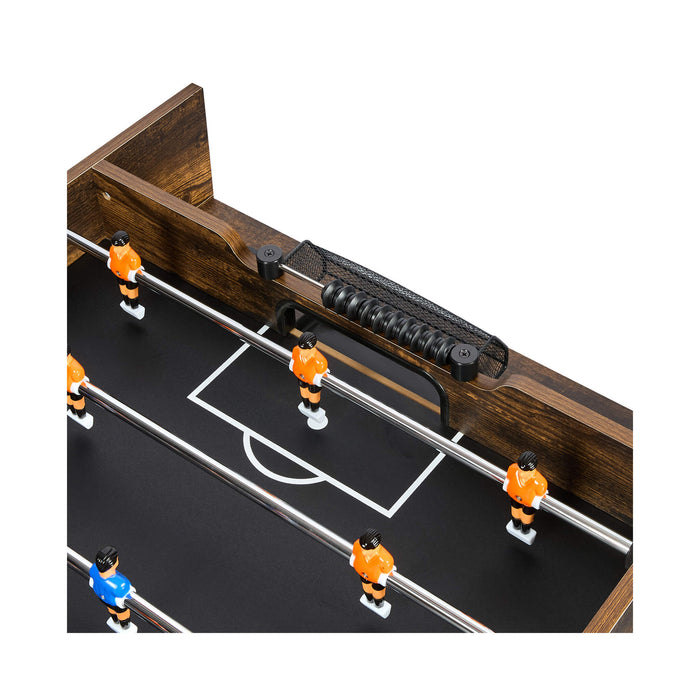 Close-up of a foosball table with players in orange and blue uniforms on a white background