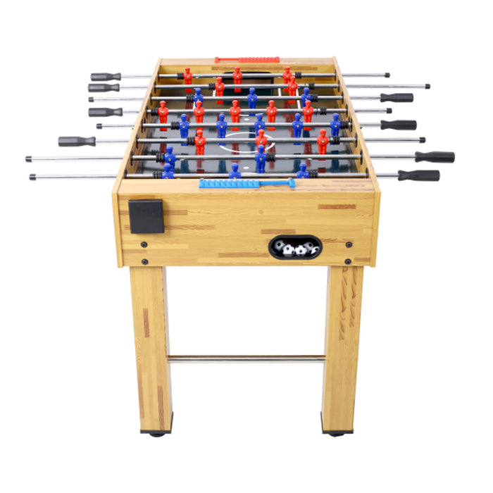 Foosball table with wooden finish and red, blue, and black players on a white background