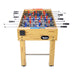Foosball table with wooden finish and red, blue, and black players on a white background