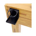 Black cup holder attached to a wooden table