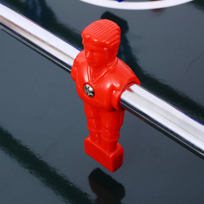 Red foosball player on a black table