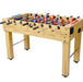Foosball table with wooden surface and metal legs on a white background