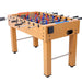 Foosball table with wooden surface and metal rods on a white background
