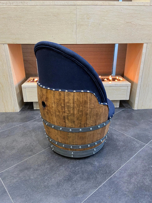 Wooden barrel with a blue cover on a tiled floor, with a fireplace in the background.