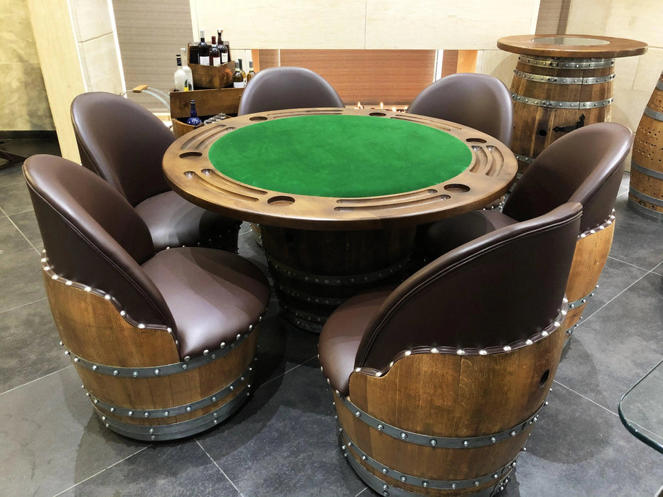 Poker table with green felt surface surrounded by barrel chairs in a room setting.