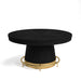 Round black table with a gold base on a white background