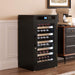 Black wine cooler with wine bottles inside, placed in a room with a wooden floor and beige walls.