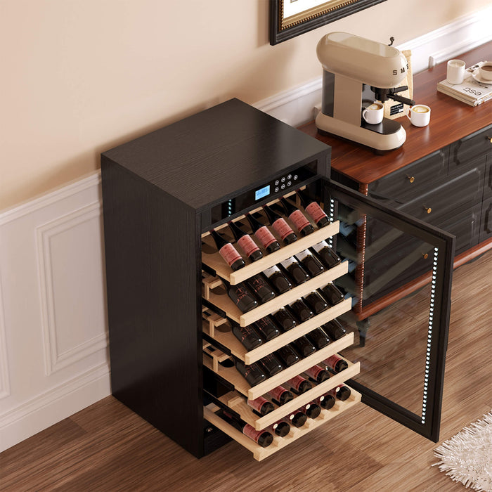 Wine cooler with wine bottles inside, placed next to a coffee machine on a wooden counter.