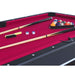 Pool table with pool cues, balls, and accessories on a red felt surface.