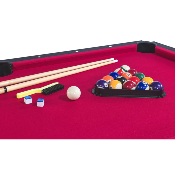 Pool table with pool balls, cues, and accessories on a red felt surface.