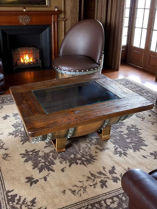 Wooden coffee table with metal legs in a room with a fireplace and curtains.