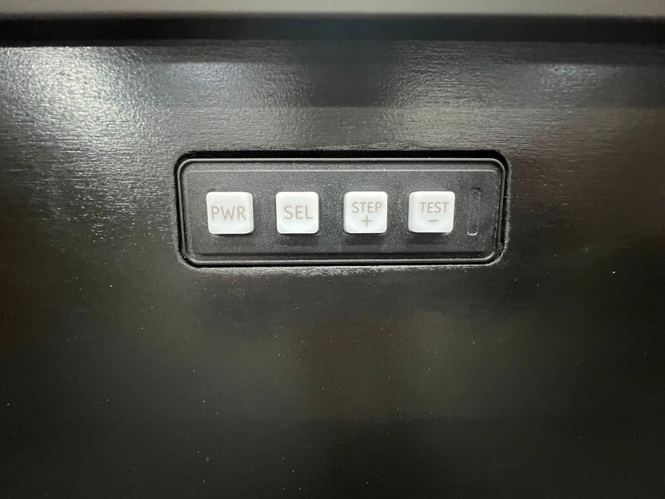 Control panel with four buttons labeled PWR, SEL, STEP, and TEST on a black surface.