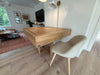 Wooden dining table with a chair in a living room setting