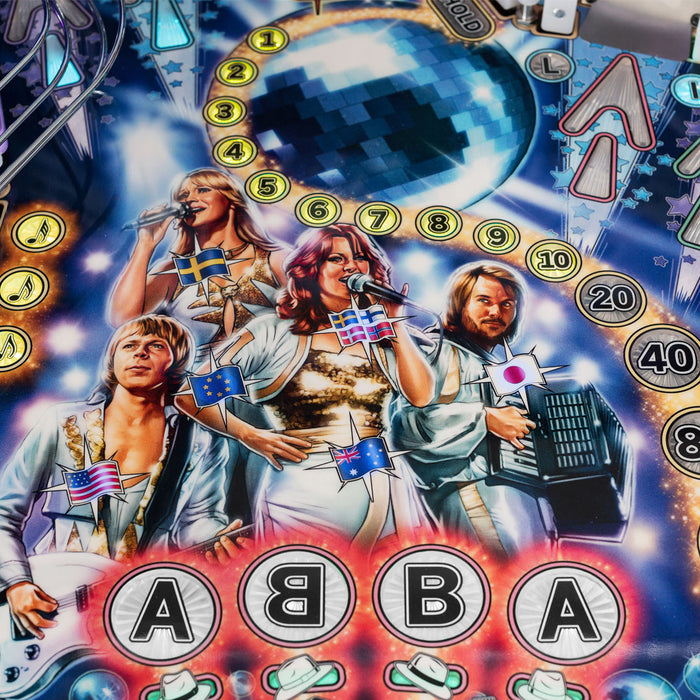 Pinball machine with ABBA-themed artwork featuring the band members and their names.