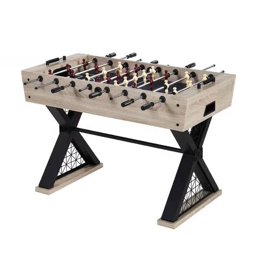 Foosball table with wooden surface and black metal legs on a white background