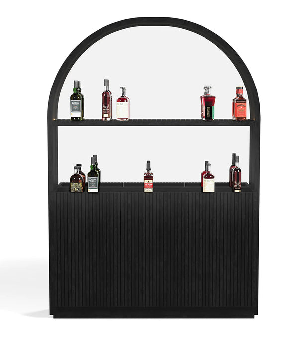 Black bar cart with glass front displaying various bottles on a white background