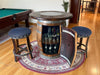 Wooden barrel bar with bar stools in a room with a pool table.