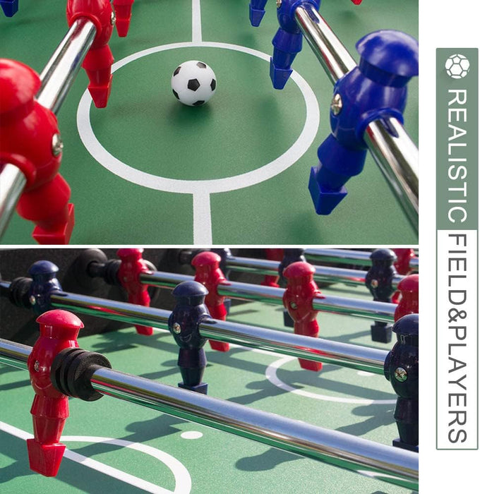 Close-up of a table football game with players and ball on a green field.