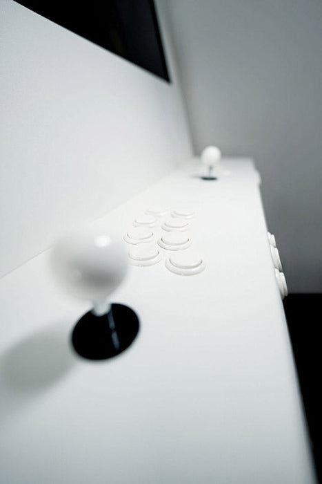 Close-up of a white electronic device with control buttons on a blurred background