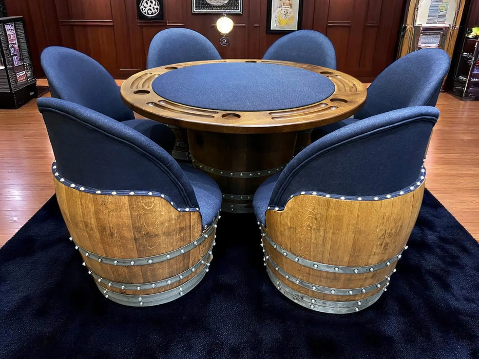Wooden poker table with blue felt surface surrounded by barrel-style chairs in a room setting.