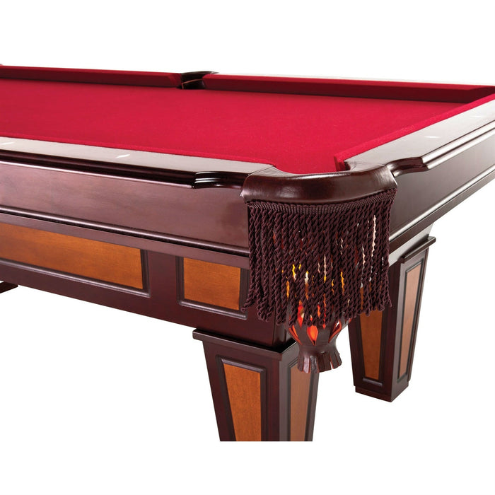 Pool table with red felt surface and decorative corner piece on a white background