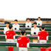 Table football set with red and white players on a green field