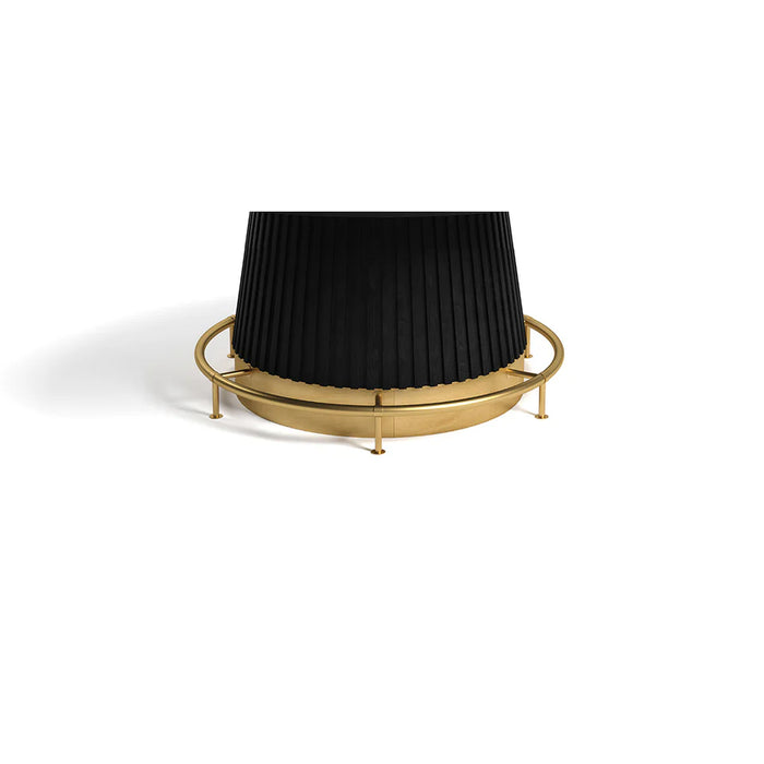 Black pleated lampshade on a gold metal stand against a white background
