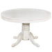 Round white table with a decorative pedestal base on a white background
