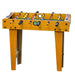 Wooden foosball table with player figures on a white background