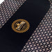 Black poker table with gold Triton Poker logo and patterned edges