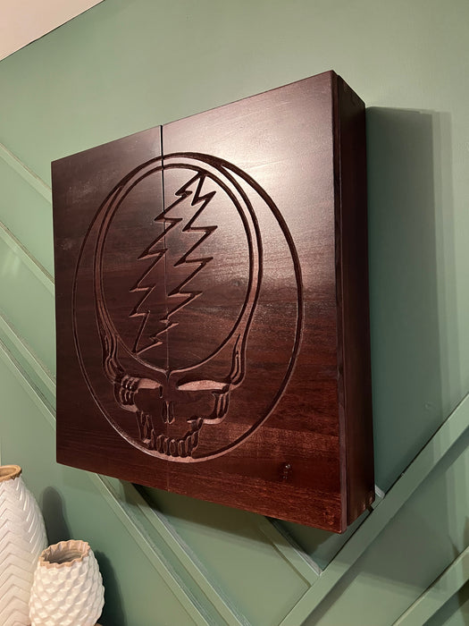 Wooden box with a Grateful Dead logo on a green wall