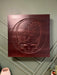 Wooden plaque with Grateful Dead logo on a wall.