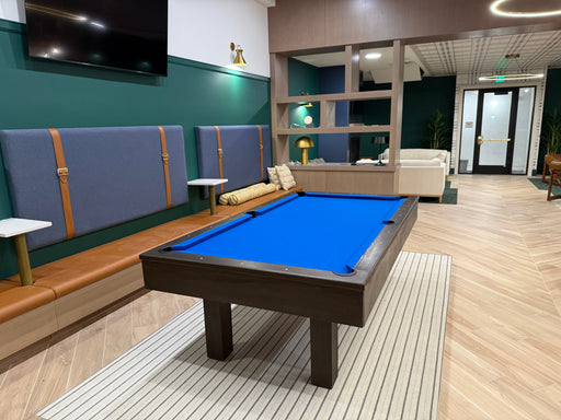 Billiards room with pool table, seating area, and modern decor.