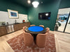 Game room with a blue poker table and chairs in a modern kitchen.